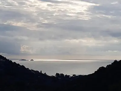 a view of the ocean under a cloudy sky at CORSACASA Villa in Palombaggia sea view in Porto-Vecchio