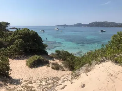 a view of a beach with boats in the water at CORSACASA Villa in Palombaggia sea view in Porto-Vecchio
