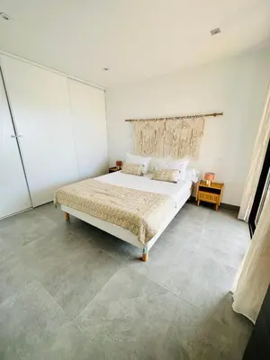 a bedroom with a large bed in a room at T2 « Bohème » avec Spa… in Calenzana