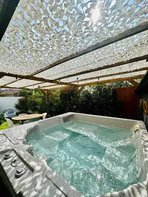 a jacuzzi tub under a pergola at T2 « Bohème » avec Spa… in Calenzana