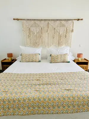 a bedroom with a large white bed with pillows at T2 « Bohème » avec Spa… in Calenzana