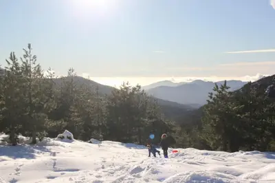 a couple of people standing on top of a snow covered mountain at Appartement avec vue sur la montagne in Vico