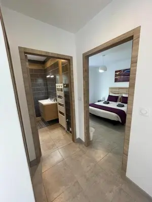 a bedroom with a bed and a bathroom with a mirror at Villa Casa Sognu di Orizonte in Figari