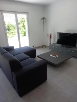 a living room with a couch and a coffee table at Villa Casa Sognu di Orizonte in Figari