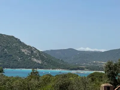 a view of a lake with mountains in the background at Studio de charme à 300 m de la Plage de Santa Giulia in Porto-Vecchio