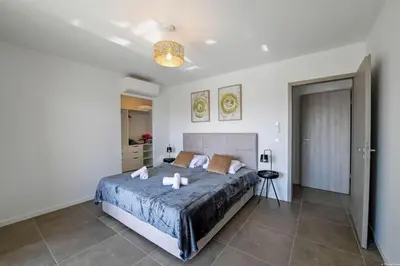 a bedroom with a large bed with two candles on it at LA MAISON ORIZONTI in Cirendinu