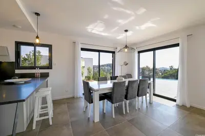 a kitchen and dining room with a table and chairs at LA MAISON ORIZONTI in Cirendinu