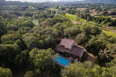 an overhead view of a house with a pool in the woods at Domaine Finili in Cauro