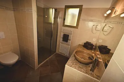 a bathroom with a sink and a shower and a toilet at Domaine Finili in Cauro