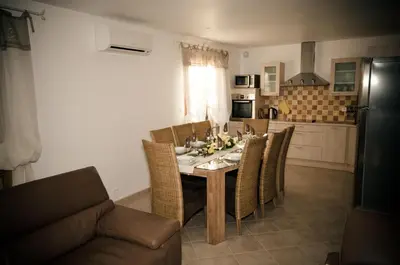 a dining room table and chairs in a kitchen at Domaine Finili in Cauro