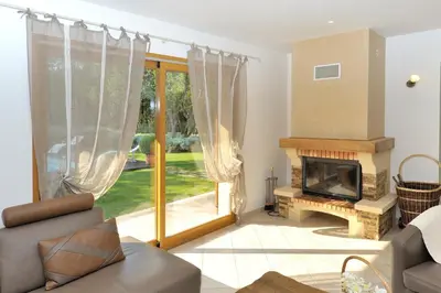 a living room with a couch and a fireplace at Domaine Finili in Cauro