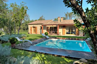a backyard with a pool and a house at Domaine Finili in Cauro