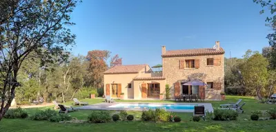 a large stone house with a pool in front of it at Domaine Finili in Cauro