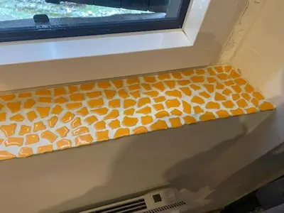 an orange and white window mat on a window sill at LE RELAIS DES COLS in Cozzano