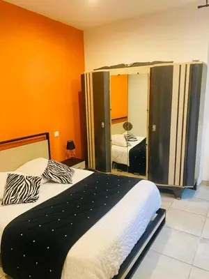 a bedroom with a large bed and a mirror at LE RELAIS DES COLS in Cozzano