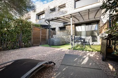 a backyard with a patio with a grill and a building at N10 Maison T2 climatisé avec jacuzzi privé in Ajaccio