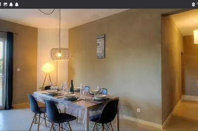 a dining room with a table with chairs and a light at Maison CALM2 in Viggianello