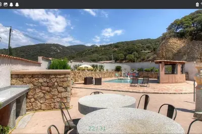 a patio with tables and chairs and a pool at Maison CALM2 in Viggianello