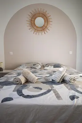 a bed with a blanket and a mirror on it at N1 Maison T2 climatisé in Ajaccio