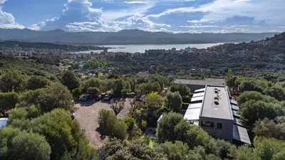 an aerial view of a building with trees and a lake at N1 Maison T2 climatisé in Ajaccio