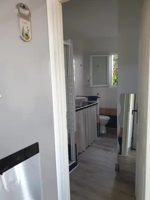 a white kitchen with a sink and a toilet at Casa Elena in Ajola