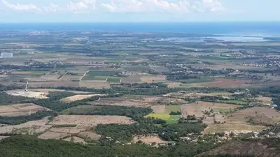 an aerial view of a field and the ocean at Casa Elena in Ajola