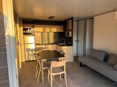 a living room with a table and chairs and a couch at Les collines de lava in Appietto