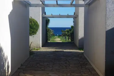 a hallway with a view of the ocean from a building at Résidence A NUCIOLA Les pieds dans l'eau Cervione Hte CORSE in Cervione