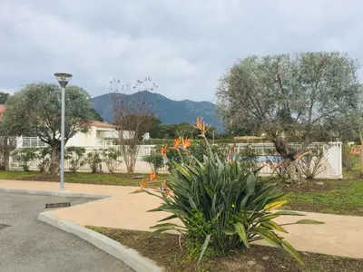 a park with a street light and some plants at Résidence A NUCIOLA Les pieds dans l'eau Cervione Hte CORSE in Cervione