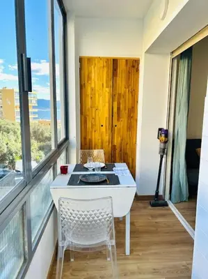 a room with a table and chairs and a window at Charmant studio Sanguinaires in Ajaccio