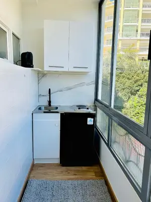 a small kitchen with a sink and a window at Charmant studio Sanguinaires in Ajaccio