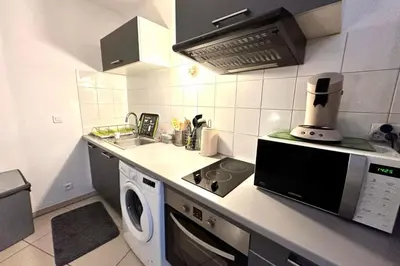 a kitchen with a washer and a sink and a microwave at Charming 45m in Sarrola carcopino in Sarrola-Carcopino