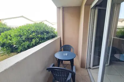 a small blue table and chairs on a balcony at Charming 45m in Sarrola carcopino in Sarrola-Carcopino