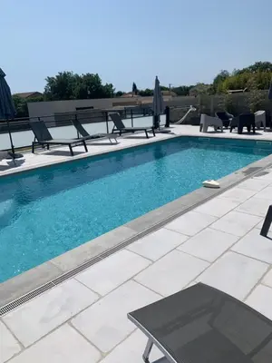 a swimming pool with chairs and a table at A 700m de la plage,villa FAMIGLIA avec piscine in Santa-Lucia-di-Moriani