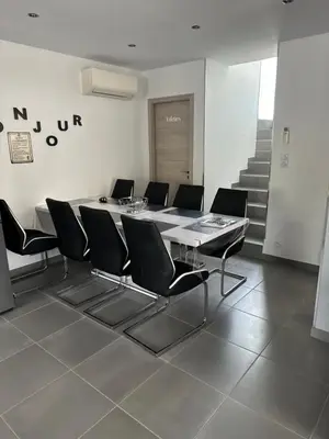 a table and chairs in a room with a staircase at A 700m de la plage,villa FAMIGLIA avec piscine in Santa-Lucia-di-Moriani