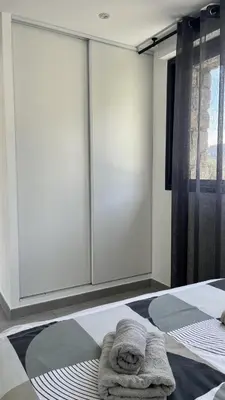 a bedroom with a bed with a towel on it at N2 Maison T2 climatisé in Ajaccio