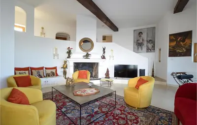 a living room with yellow chairs and a fireplace at Lovely Home In Porticcio in Porticcio