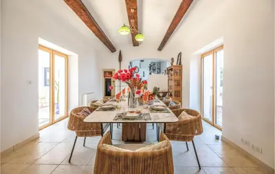 a dining room with a table and chairs at Lovely Home In Porticcio in Porticcio