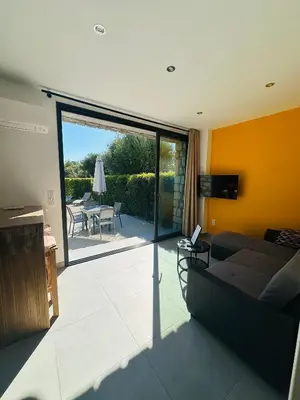 a living room with a couch and a patio at N3 Maison T2 climatisé in Ajaccio