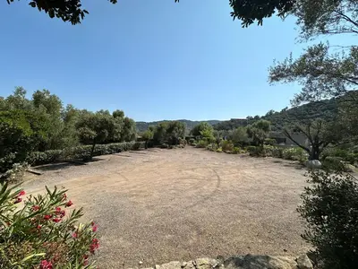 a large gravel field with trees and bushes at N3 Maison T2 climatisé in Ajaccio