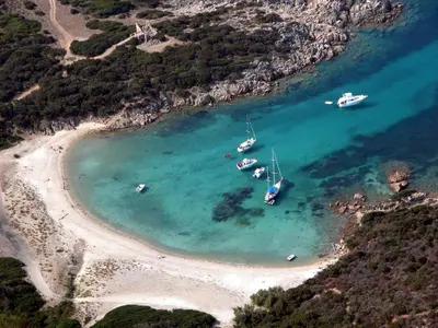 a group of boats in the water on a beach at Résidence de tourisme Les Hauts de l'Avena in Sartène