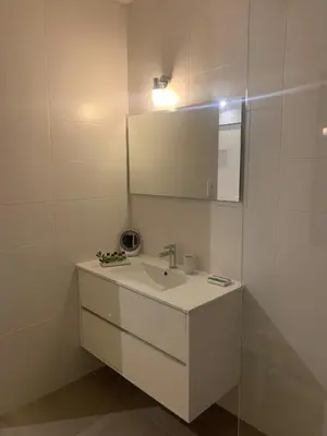a white bathroom with a sink and a mirror at CasaCanetto villa, suites et piscine chauffée in Bonifacio