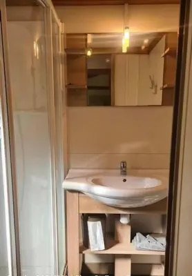 a bathroom with a sink and a mirror at RAS L'BOL in Olmeto