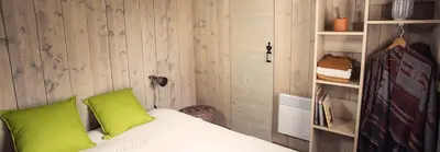 a bed with two green pillows in a room at RAS L'BOL in Olmeto