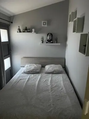 a bedroom with a bed with two pillows on it at La Bergerie Furiani avec piscine privée Residence Digoune in Furiani