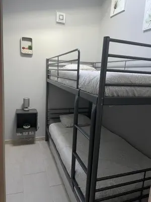 two bunk beds in a room with a tv at La Bergerie Furiani avec piscine privée Residence Digoune in Furiani