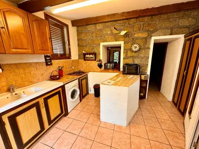 a kitchen with a sink and a dishwasher at Casa Jeannot typique Corse en pierre, UNIQUEMENT DE SAMEDI EN SAMEDI , 2 pers, f2, 35 m2, jardin 60m2 vue montagne, parking in Monacia-dʼAullène