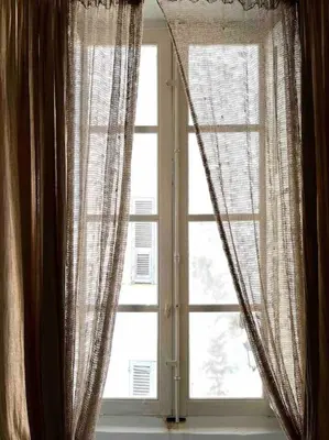 a window with curtains in a room at 83m2 de charme au coeur de la cité impériale in Ajaccio
