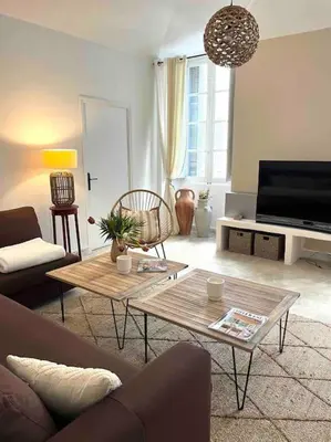 a living room with a couch and a table at 83m2 de charme au coeur de la cité impériale in Ajaccio