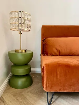 a lamp sitting on top of a green table next to a couch at Studio hyper centre in Ajaccio